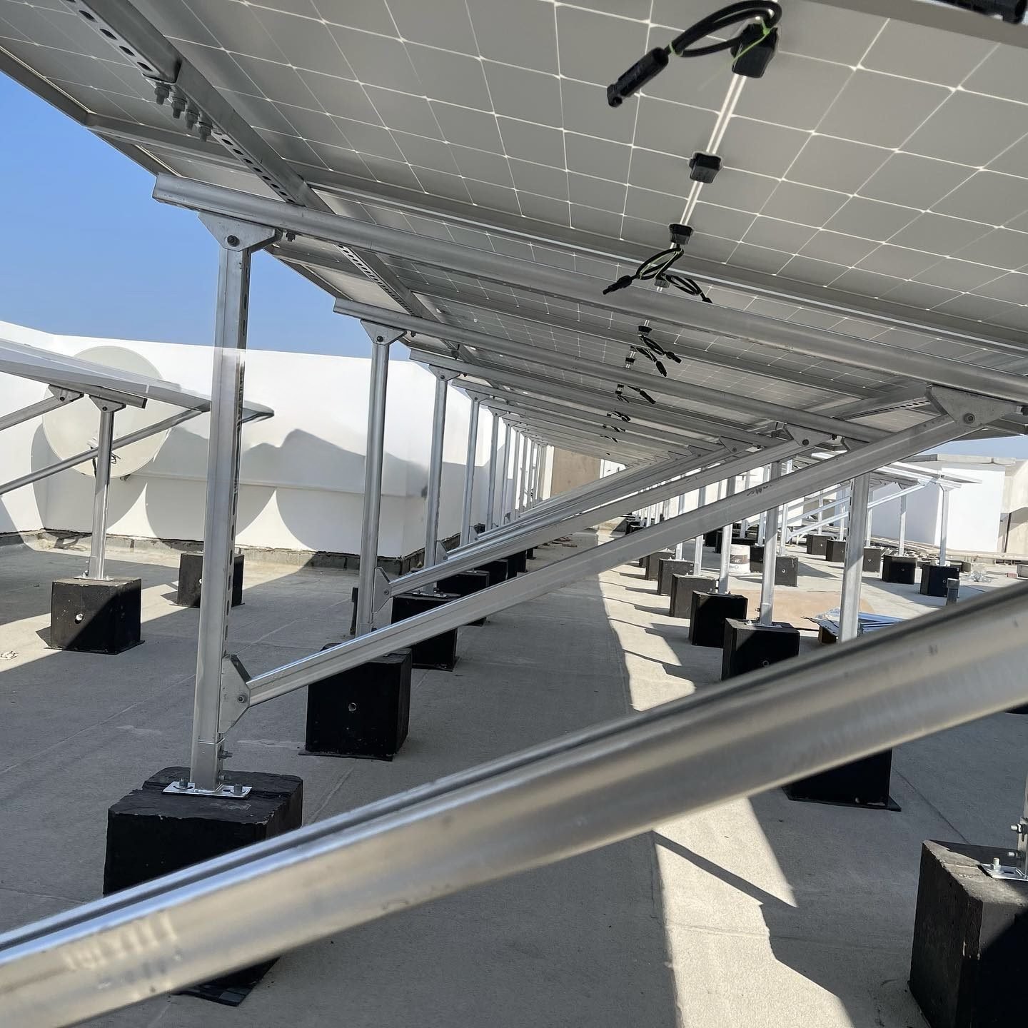 Underside of rooftop solar panels showing metal mounting frames and support structures for solar installation in Phuket.