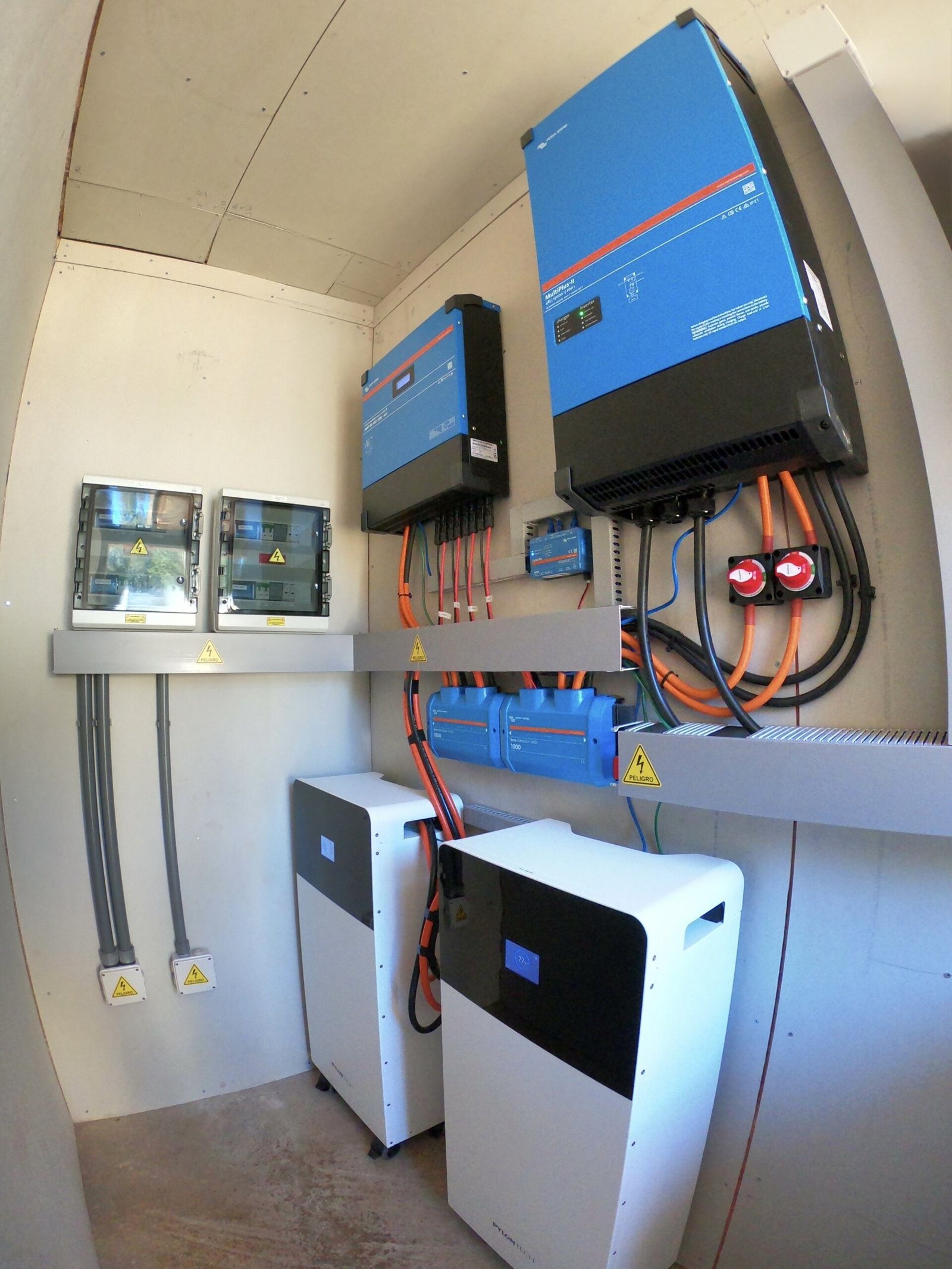 Hybrid solar inverter with connected battery storage system, electrical wiring and protection equipment.