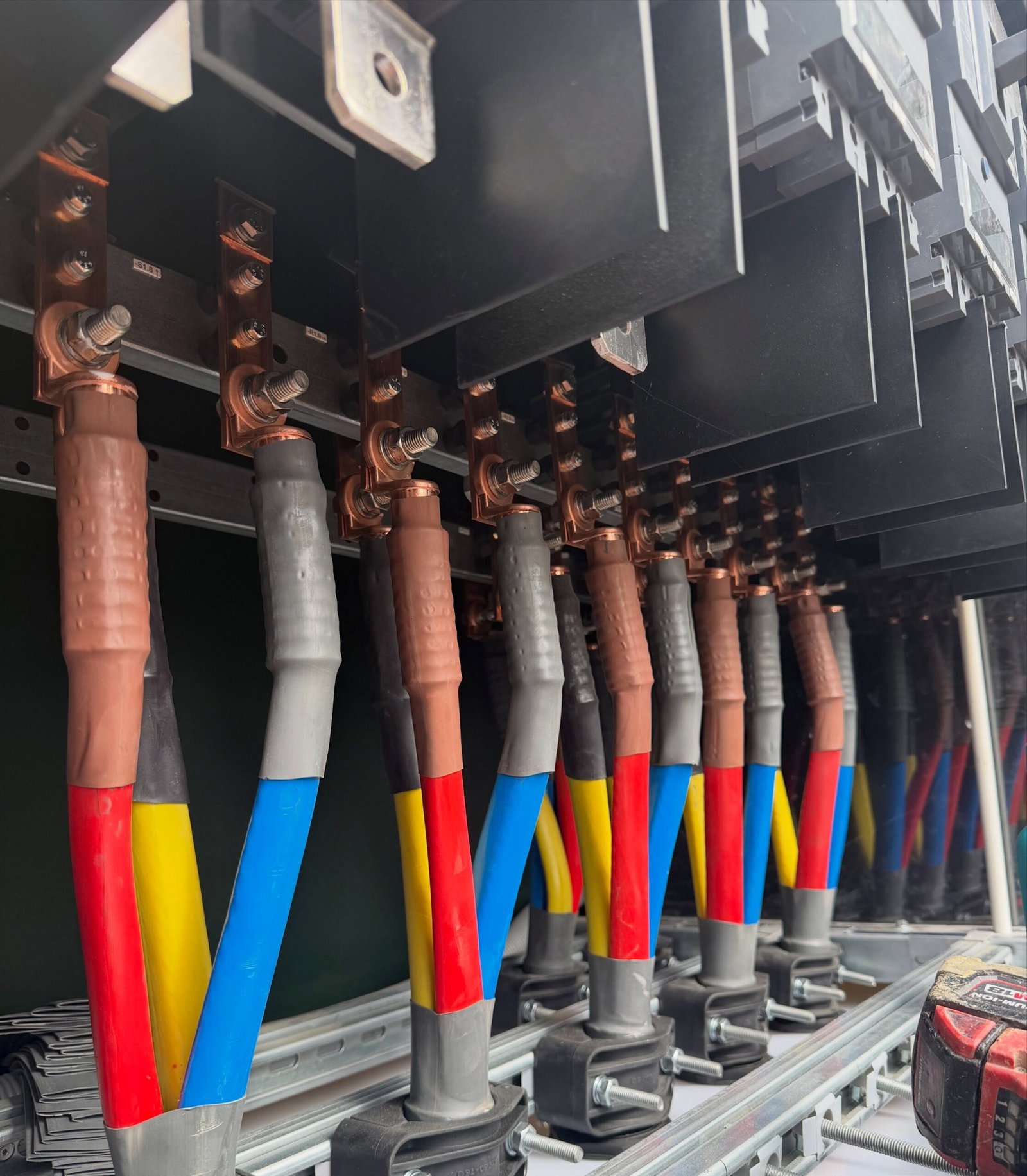 Close-up of electrical cables and connections inside a solar power distribution and protection system.