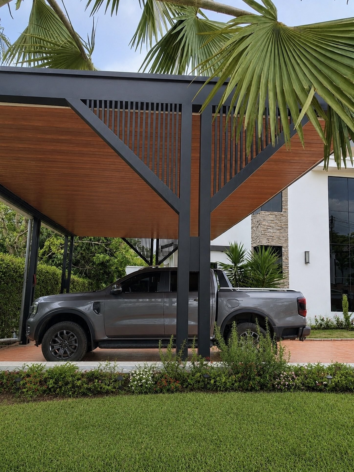 Modern metal-frame carport canopy providing covered parking for a pickup truck