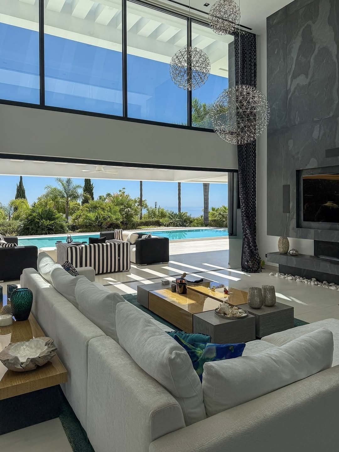 Luxury villa interior in Phuket with floor- to -ceiling windows, modern flooring, and high-quality finishes