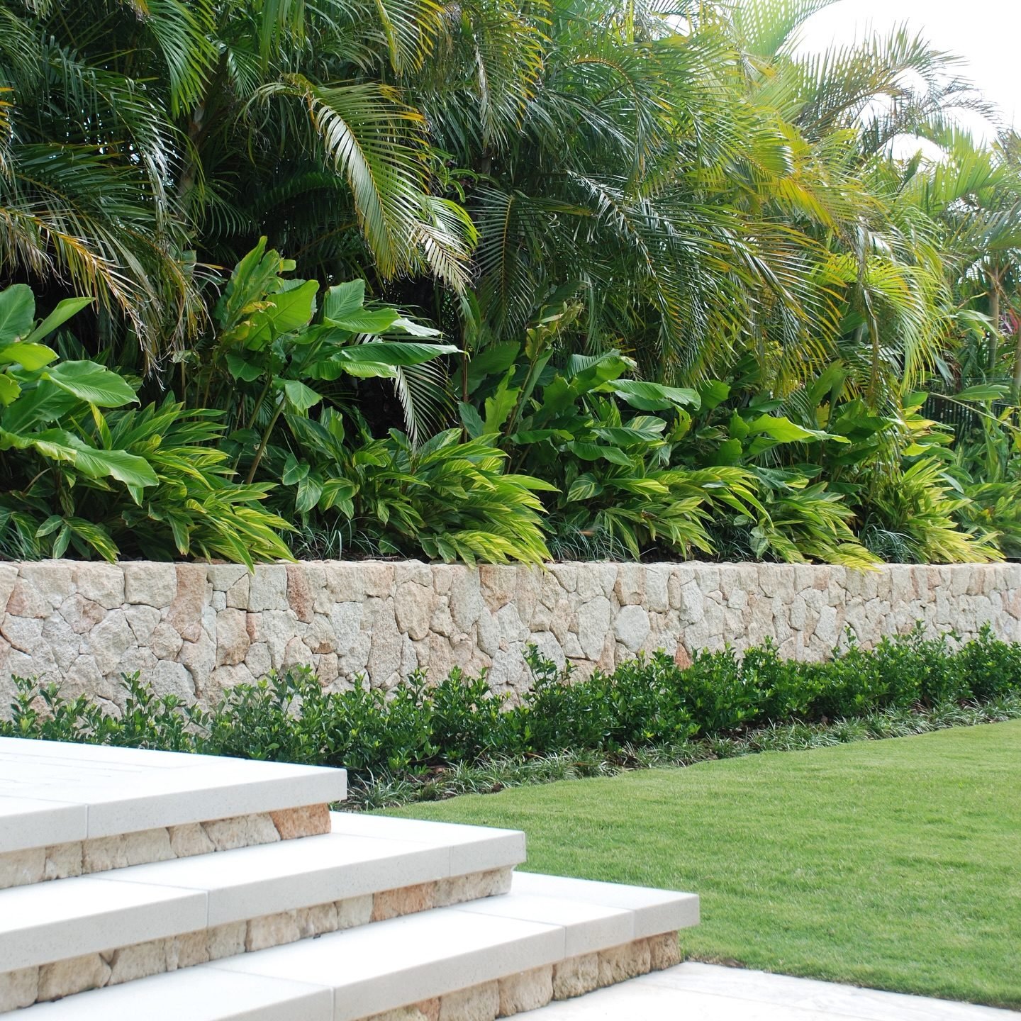 Stone retaining wall with tropical landscaping at the villa in Phuket