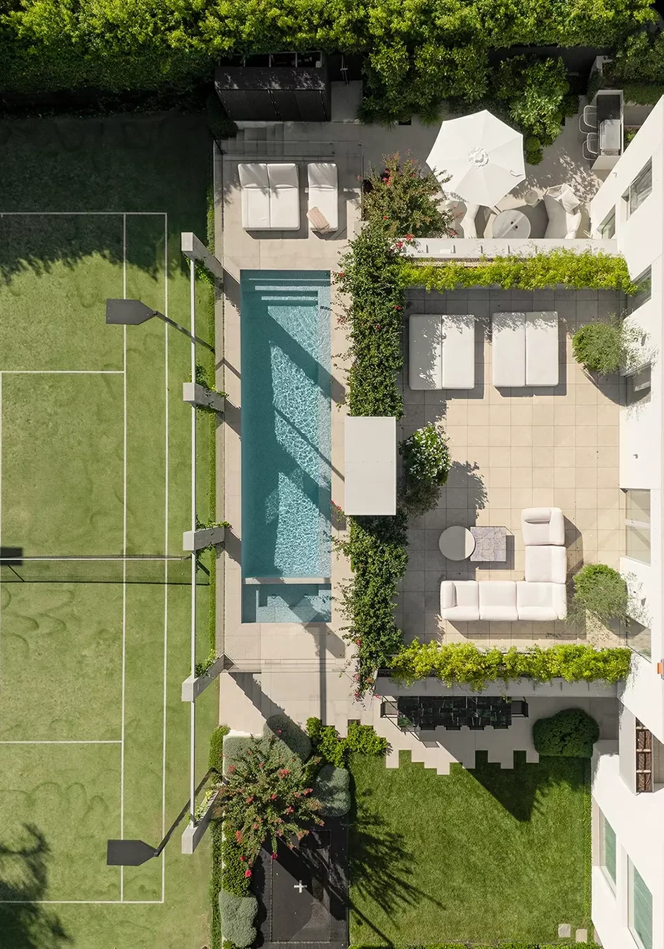 Aerial view of villa landscaping with green lawn, swimming pool, outdoor terrace and tropical plants in Phuket